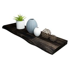 three vases are sitting on top of a wooden tray with plants in it and one is empty