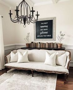 a living room with a white couch and chandelier