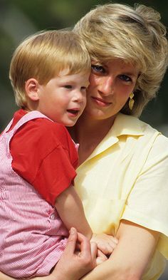 a woman holding a small boy in her arms