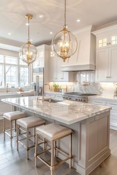 a large kitchen with marble counter tops and stools