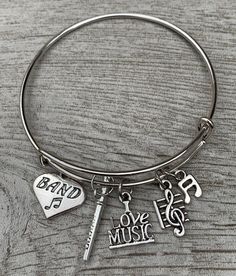 BAND JEWELRY- Flute Charm Bangle Bracelet for Girls, Teens and Women MARCHING BAND BRACELET- Silver plated music charms on bangle bracelet ADJUSTABLE- Easily Adjusts to Fit your Wrist 5" to 8" Adjustable Length GIFT IDEAS -Perfect gifts for her (birthday or just because) FREE JEWELRY POUCH- Only The Most Elegant Velvet Jewelry Pouches Are Used To Package And Ship Our Bracelets, Ensuring The Most Beautiful Presentation Possible. Marching Band Flute, Music Bracelet, Bracelet For Girls, Band Mom, Sewing To Sell, Gifts For Her Birthday, Jewelry Pouches, Music Jewelry, Velvet Jewelry