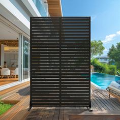 an outdoor living area with wooden decking and sliding glass doors leading to the pool