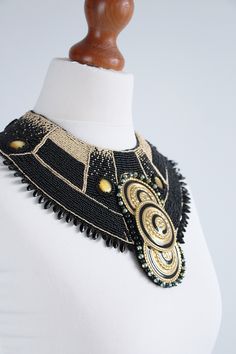 This is extra large black statement necklace made of two colors: black and gold. Large black collar necklace inspired by Art Deco Cleopatra costume. Yes, this is my favorite Art deco Cleopatra costume necklace. Perfect for black outfit, fits well on top on the garment and open shoulder dress. Collar necklace is adjustable, fits of each size of neck. Chunky necklace made only of seed beads and glass beads. It's huge, it's unique and one of a kind statement jewelry piece. Very festive and solemn s Unique Gold Beaded Choker, Unique Black Beaded Jewelry For Party, Gold Bib Necklace With Colorful Beads, Unique Black Beads Necklace For Party, Gold Beaded Necklaces With Black Beads, Unique Gold Beaded Necklace With Black Beads, Unique Gold Necklace With Black Beads, Unique Black Beaded Necklace With Spacer Beads, Unique Black Beaded Choker