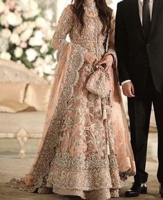 a man and woman in formal wear standing next to each other