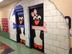 two doors decorated with paper cut outs and characters on them, in a school hallway