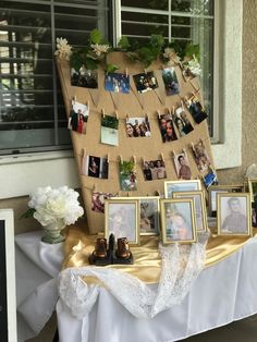 a table topped with pictures and photos next to a window