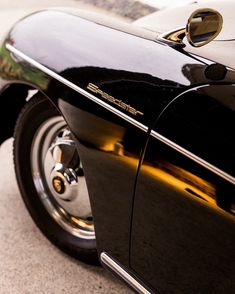 the front end of a classic black car