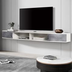 a flat screen tv sitting on top of a white entertainment center