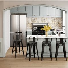 a kitchen with three stools and a center island in the middle of the room