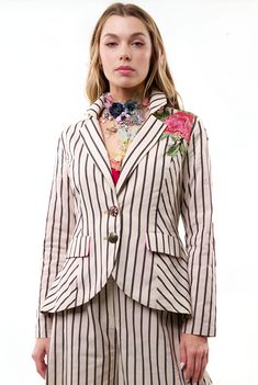 This Aratta Derby Princess Stripe Blazer is definitely a statement! This blazer and pant is a must-have this season. This blazer is embellished in embroidered floral design. Perfect for layering and giving your look boss vibes. Featuring a soft velvet elbow patch, long sleeve, and embroidered floral patches on the back of the blazer, flared long pants. Giving you a relaxed fit this must-have style. Pair this with a lace top or fitting bodysuit pumps for a complete look. Stripe button-up blazer with embroidered floral patch on front & back shoulder, contrast velvet elbow patches, 2 flap pockets, Cream And Black Stripes Combo Soft Beautiful Velvet Elbow Patches Regular fit Floral Des Embroidered Patch Work 2 Flap Pockets Long Sleeve Satin Lining 2 Button Closure Blazer Self fabric: 100% Cott Spring Embroidered Notch Lapel Blazer, Spring Tailored Embroidered Blazer, Tailored Floral Embroidered Blazer For Spring, Spring Tailored Blazer With Embroidery, Embroidered Notch Lapel Blazer For Work, Spring Embroidered Tailored Blazer, Spring Embellished Fitted Blazer, Workwear Embroidered Blazer With Notch Lapel, Fitted Floral Embroidery Blazer For Work