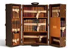 an open book case filled with lots of books on top of a yellow flooring