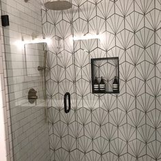 a white tiled bathroom with black accents