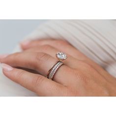 a woman's hand with two rings on top of her ring and the other one is