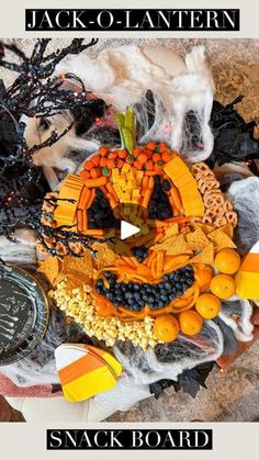 an arrangement of halloween candy and decorations on a table with the words jack - o - lantern