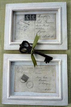 two white frames with keys tied to them on a green and white checkered table cloth