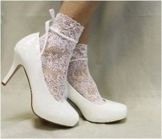 COSMOPOLITAN lace socks for heels - white Elevate your look with our stretch lace socks with satin bows. Perfect for heels and Mary Jane shoes. Great sock style for a modern wedding, special occasion. Step into elegance with our COSMOPOLITAN lace socks for heels in white. These socks feature a delicate and stretchy lace design adorned with satin bows, perfect for stepping into your favorite heels or Mary Jane shoes. Add a touch of luxurious sophistication to any outfit with these lace socks, perfect for a modern wedding or special occasion. delicate nylon lace sock no heel, fits average feet 6-9 exclusive design * Signature socks by Catherine Cole Quality lace socks for women  Women have been calling our socks their signature look for many years Frilly Socks And Heels, White Lace Socks, Hosiery Dress, Lace Sock, Lace Ankle Socks, Socks Lace, Frilly Socks, Wedding Socks, Lace Stockings