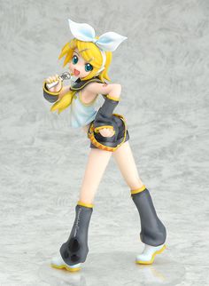 a figurine that is standing up on a white surface and holding a baseball bat