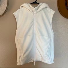 Classic Fp Movement Gem! Add This Fleece Vest To Your Athleisure Or All Around Loungewear Must-Haves. Great For The Gym, Around The House Or Layering Over A Long Sleeve Top. Condition: Worn Less Than Three Times, It’s Nearly Brand New To Excellent. It’s Been Hanging In A Non-Smoker’s Closet. Size: L Color: Light Cream / Cactus Milk White Details: Hooded, Fleece, High-Neck Zip, Pockets, Elastic Cinch Waist, Solid Classic Color, Regular Relaxed Fit And Soft. Care: Like Colors, Gentle Cold. Like Fo White Fleece Outerwear With Drawstring Hood, White Fleece Hooded Jacket For Cold Weather, White Hooded Jacket With Drawstring For Cold Weather, White Fleece Jacket With Drawstring Hood For Winter, White Hoodie With Pockets For Cold Weather, Cozy White Fleece Hooded Jacket, Cozy White Hooded Jacket With Adjustable Hood, White Fleece Outerwear With Adjustable Hood, White Fleece Sports Jacket For Winter