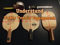 three ping pong paddles sitting next to each other on a table with measurements