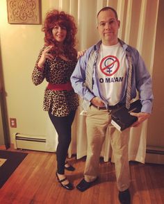 the man and woman are dressed up in costumes for an event or costume party they are standing next to each other