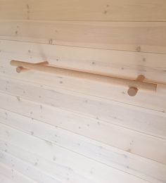 a wooden wall with two hooks on it