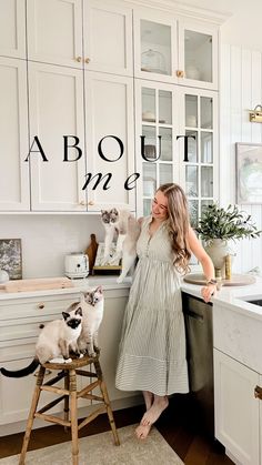 a woman standing in a kitchen with two cats on the counter and an advertisement above her that says about me