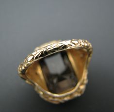 "PRE-OWNED For Sale: (1) Beautiful Vintage Emerald Cut Smokey Quartz Mounted in a 14k Yellow Gold Ring PLEASE READ ENTIRE DESCRIPTION BEFORE PURCHASING Please see pictures for more details! This is a lovely emerald cut smokey quartz ring in 14k yellow gold filigree mounting with bows on each side. The embossed filigree design does cover the whole ring band. This ring is stamped 14k. A very nice ring. Specifics: 14k Yellow Gold Smokey Quartz approx. 16 mm x 11.3 mm Size: 7 Weight - 5.8 grams If y Luxury Gold Jewelry With Emerald Cut, Yellow Gold Jewelry With Bezel Setting For Formal Occasions, Formal Yellow Gold Jewelry With Bezel Setting, Antique Emerald Cut Gold Jewelry, Antique Gold Emerald Cut Jewelry, Collectible 14k Gold Jewelry With Bezel Setting, Luxury Collectible Diamond-cut Jewelry, Antique Emerald Cut Yellow Gold Jewelry, Antique Bezel Setting Formal Jewelry