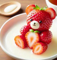 a small teddy bear made out of strawberries on a plate