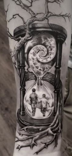 a man with a tattoo on his arm has an image of a clock and two people