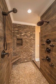 a walk in shower sitting next to a brick wall