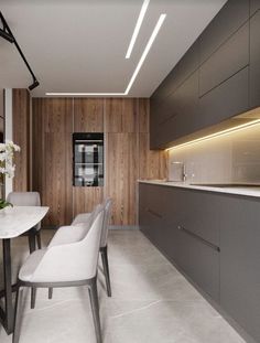 a modern kitchen with white chairs and wood paneling on the wall behind the counter