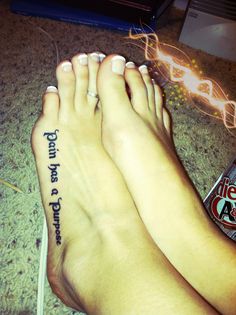 a woman's feet with tattoos on them