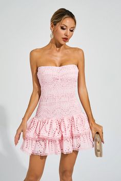 The Bridget Pink Ruffle Mini Dress exudes a sultry and feminine charm. With its elastic and flattering strapless design, it accentuates your curves beautifully. The embroidered ruffle hem adds a playful touch to this short dress. Perfect for a night on the town or a special occasion, this dress will make you feel confident and alluring.  Dress Length: Approx 63cm Materials: Polyester  Gentle Dry Clean Only  Model is 5 ft 7 and wears size S  Colour may vary due to lighting on images. The product Summer Mini Dress With Sweetheart Neckline And Ruffled Skirt, Spring Strapless Mini Dress With Ruffles, Strapless Spring Mini Dress With Ruffles, Strapless Mini Dress With Ruffles For Spring, Feminine Strapless Midi Dress For Spring, Flirty Summer Strapless Dress With Ruffled Skirt, Feminine Strapless Mini Dress For Summer, Feminine Fitted Strapless Bandeau Dress, Pink Strapless Dress With Ruffle Hem For Spring