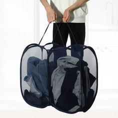 a man holding two bags with clothes in them