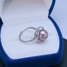 Make a statement with the 11-12mm Freshwater Pearl & Rose Ring from House of Pearls. This eye-catching ring features a luminous freshwater pearl in hues of pink and rose, encircled by polished silver. Its timeless design allows you to wear it both day and night, adding an elegant touch to your look. Whether it’s a special occasion or a casual everyday look, the 11-12mm Freshwater Pearl & Rose Ring will elevate your style with grace and charm. 11-12mm Freshwater Pearl This popular ring design fea Pearl Jewelry Ring, Pearl Rings, Popular Rings, Pearl Rose, Rose Ring, Pearl Types, Rings Jewelry, Pearl Color, Pearl Size