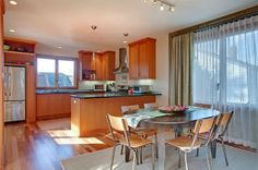 a kitchen and dining room with wood flooring