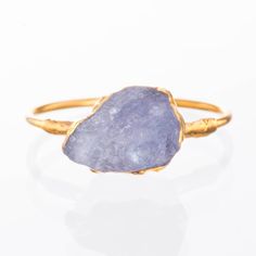 This rough tanzanite features violet hues accented by 24k yellow gold.   A great gift for December birthdays, as Tanzanite is the birthstone for December. This raw gemstone ring also exhibits complex and interesting electroforming texture around the edges of the gemstone.  This ring stacks well with other gold rings.✨14k Gold Filled Shank24k Gold Dipped for deeper color. Genuine Raw Tanzanite5-10mm wide. ✨Please read our FAQ for more information on our unique materials and process. You will rece Women Gold Ring, Raw Tanzanite, Rough Gemstone Ring, Ring Stacks, Kyanite Ring, Raw Crystal Ring, Raw Gemstone Ring, Raw Stone Ring, Boho Crystal