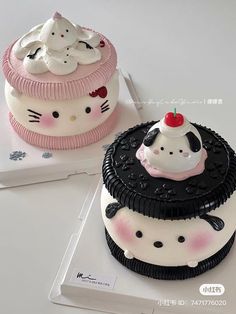 two cakes decorated to look like hello kitty are sitting on top of each other,