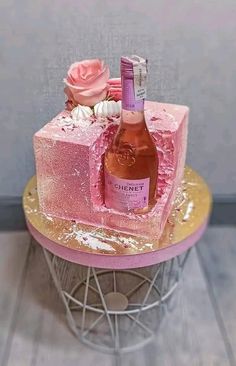 a pink cake with a bottle of wine on top