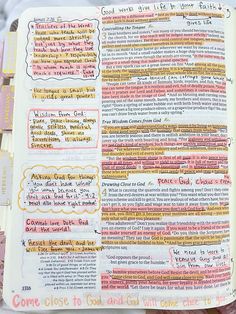 an open bible with colorful writing on the pages and some other things in it's book