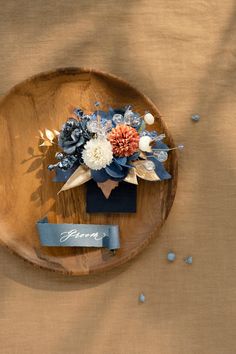 an arrangement of flowers on a wooden plate