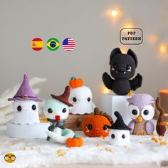 crocheted amigurma dolls are sitting in front of a white background with lights