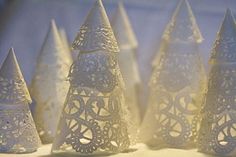 small white christmas trees sitting on top of a table