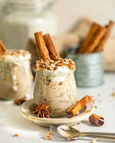 two small jars filled with food and cinnamon sticks