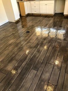 a kitchen floor that has been cleaned and is in the process of being remodeled with wood floors