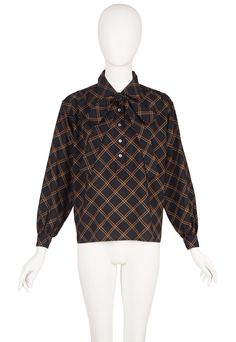 This 1970s Yves Saint Laurent Rive Gauche collared blouse was made in France of black wool challis with a plaid print. It has balloon sleeves, five shell buttons fastening the neck and a button on each cuff. It comes with the matching neck tie that attaches with a stitch at the back of the neck. It's in excellent condition, clean and ready to wear. Measurements: Bust - 41" Waistband - 41" Shoulders - 18" Sleeves - 22" Length - 24" IMPORTANT NOTE FOR CANADIAN SHOPPERS: There is a 15% shipping fee that is automatically applied to Canadian orders, as legally we need to charge and remit sales tax domestically. We will promptly refund any overcharge, and apologize for any inconvenience. Retro Fall Office Tops, Vintage Office Blouse For Fall, Vintage Blouse For Office In Fall, 1970s Style Long Sleeve Blouse For Fall, Retro Blouse For Fall, Retro Blouse For Daywear In Fall, Retro Fall Tops, Retro Tops For Fall Daywear, Retro Fall Daywear Tops