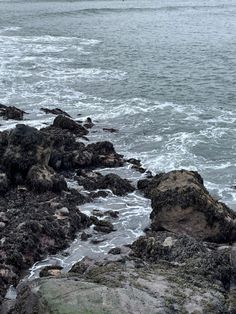 Gloomy and dark atmosphere, the photo is of a rocky shore with waves crashing against the rocks. Ocean Shore Aesthetic, The North Sea, North Sea Aesthetic, British Coastline, Scottish Coast, Sea Hag, Rocky Island, Scotland Aesthetic, Rocky Shoreline