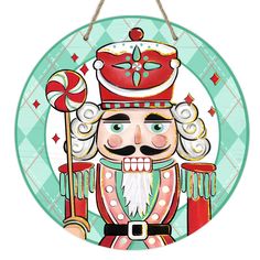 a round sign with a nutcracker holding a candy cane