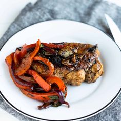 a white plate topped with meat and veggies