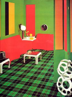 a living room filled with furniture and walls painted in green, red, yellow and orange